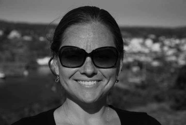 Headshot of Kristin Bivens. She wears sunglasses and is smiling